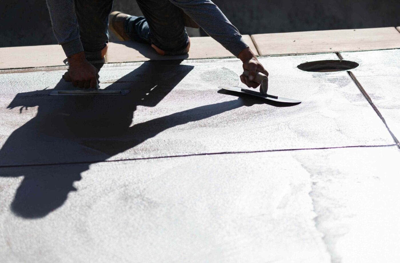 West Valley Concrete contractor finishing the patio resurfacing project with a trowel